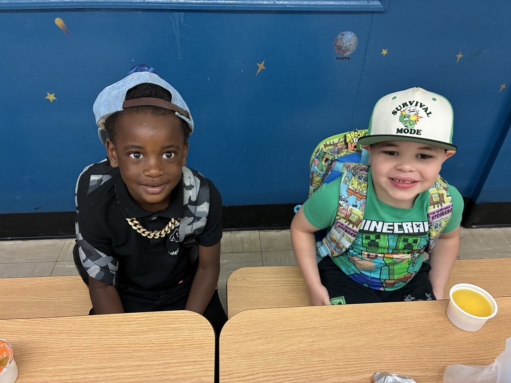 students posing with hats on