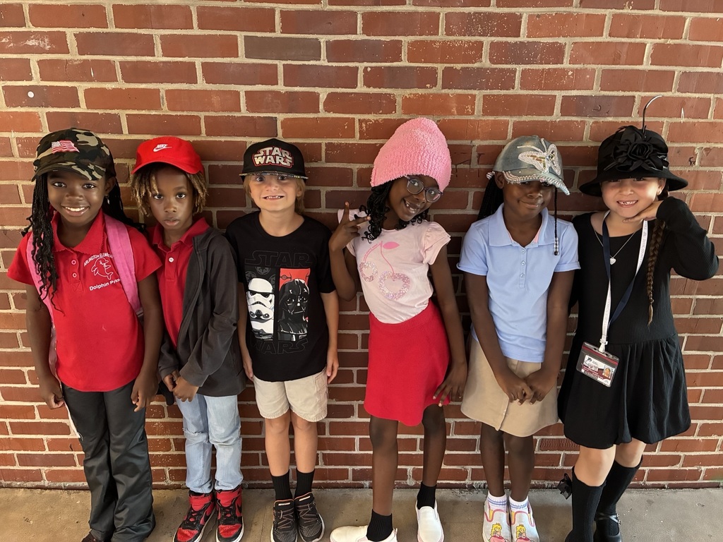 students posing with hats on