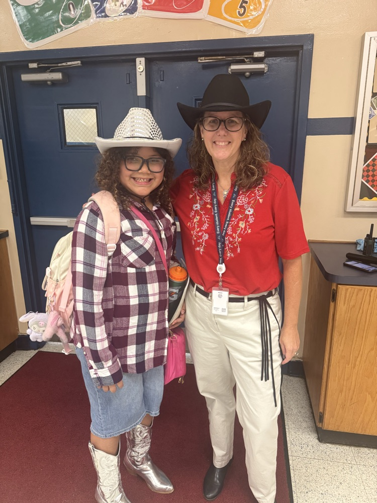 principal McCormick and a student and their cow girl hats