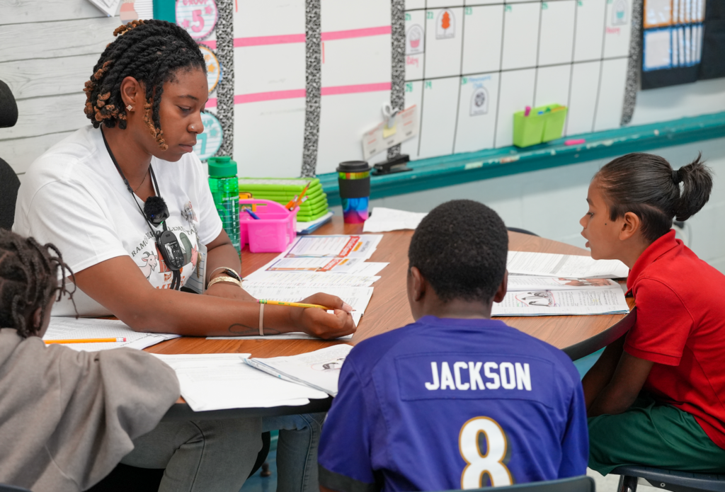 A focused moment as Jasmine Richo works one-on-one with a student during reading time.