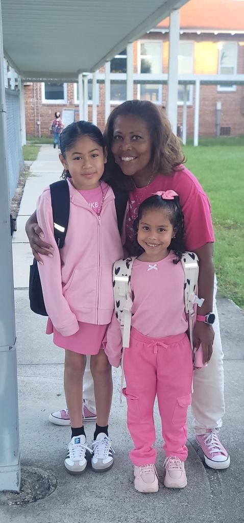 Students and principal in pink