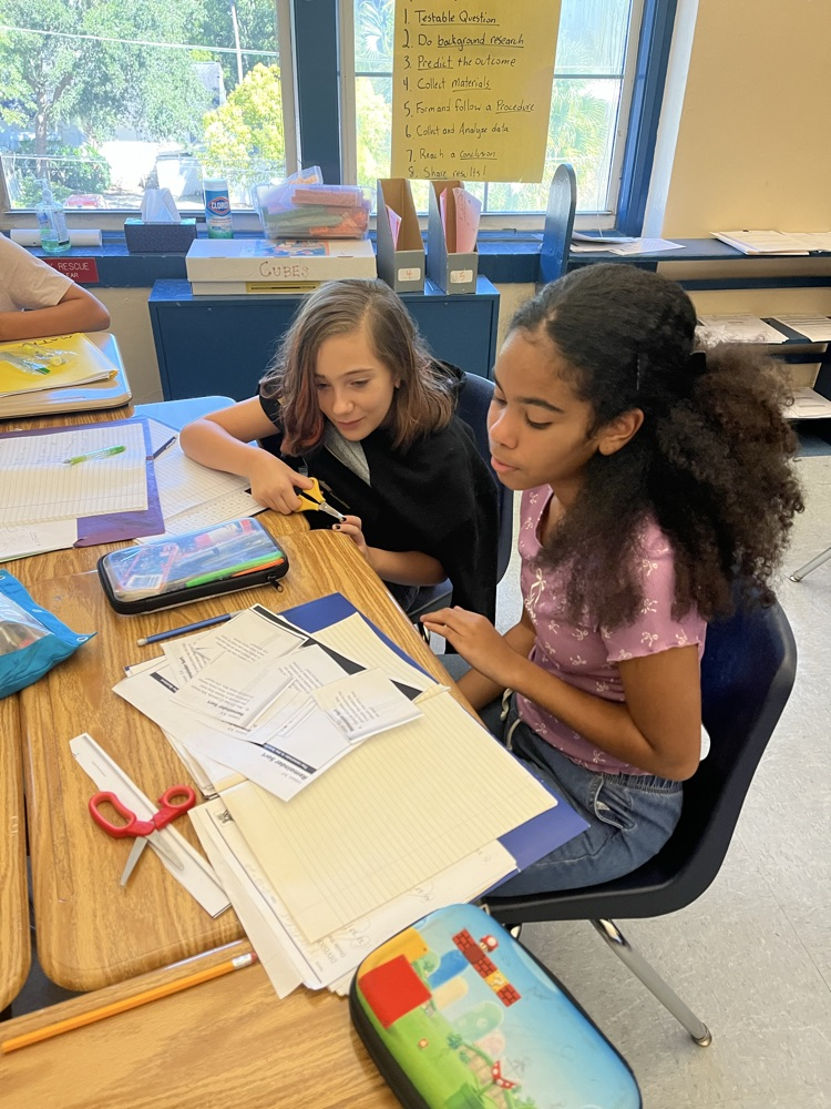 Students working together on look at problems