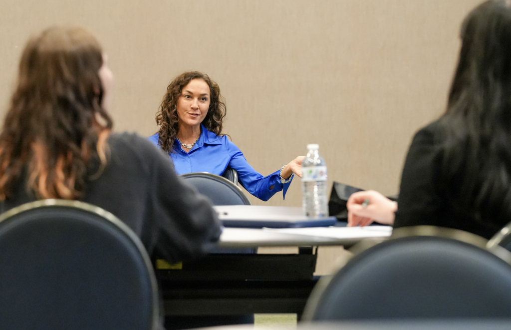 Two University of North Florida students listen attentively during a discussion at the Schultz Center for Teaching & Leadership during the “From Campus to Classroom” event.