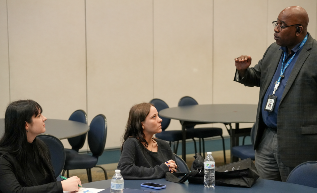 A Duval County Public Schools representative speaks with University of North Florida students about teaching opportunities during Intern Day at the Schultz Center.