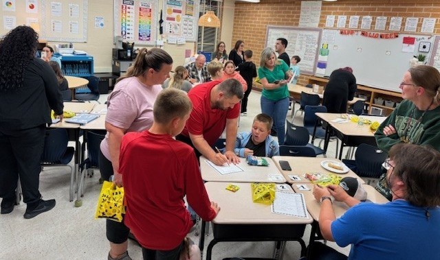Families participating in hands on math activities with their students at MAJ.