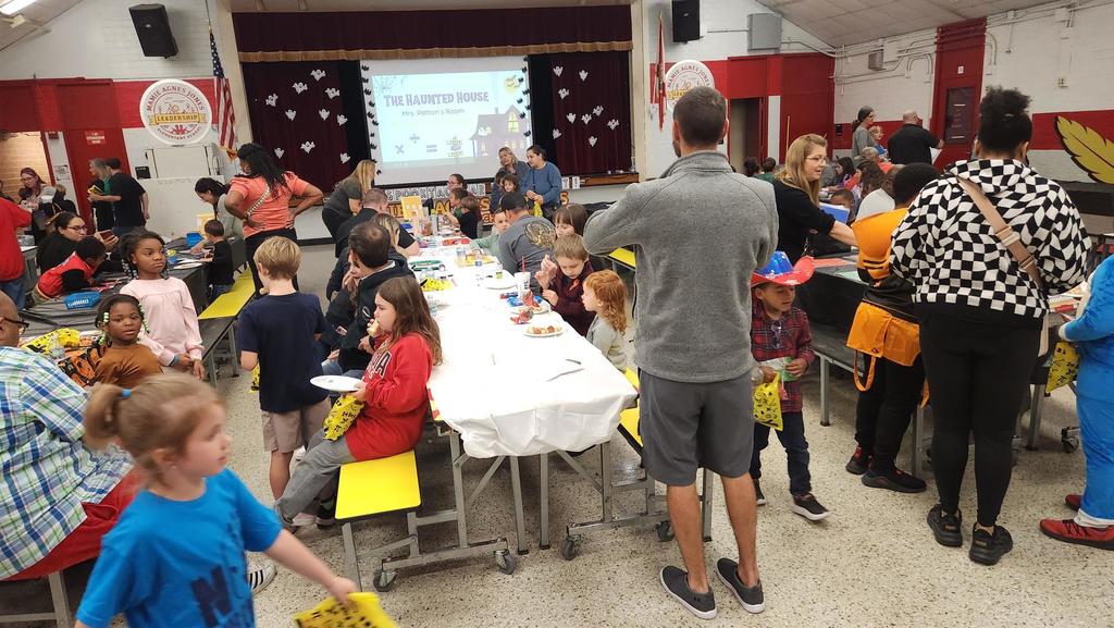 Families participating in hands on math activities with their students at MAJ.