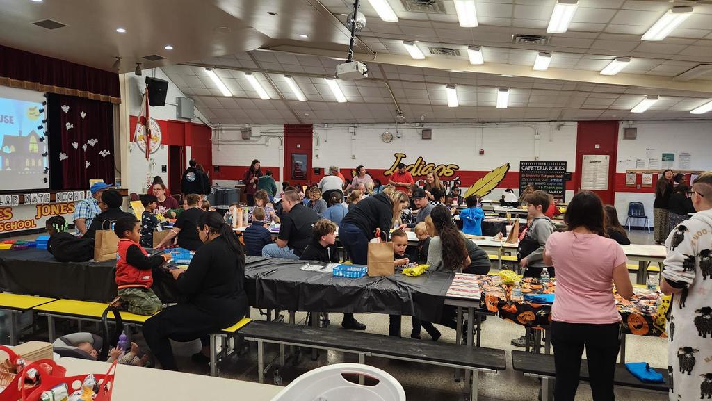 Families participating in hands on math activities with their students at MAJ.