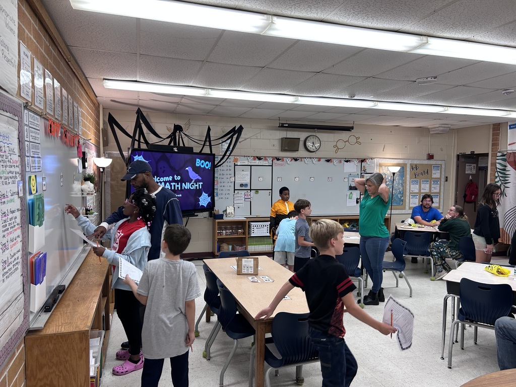 Families participating in hands on math activities with their students at MAJ.