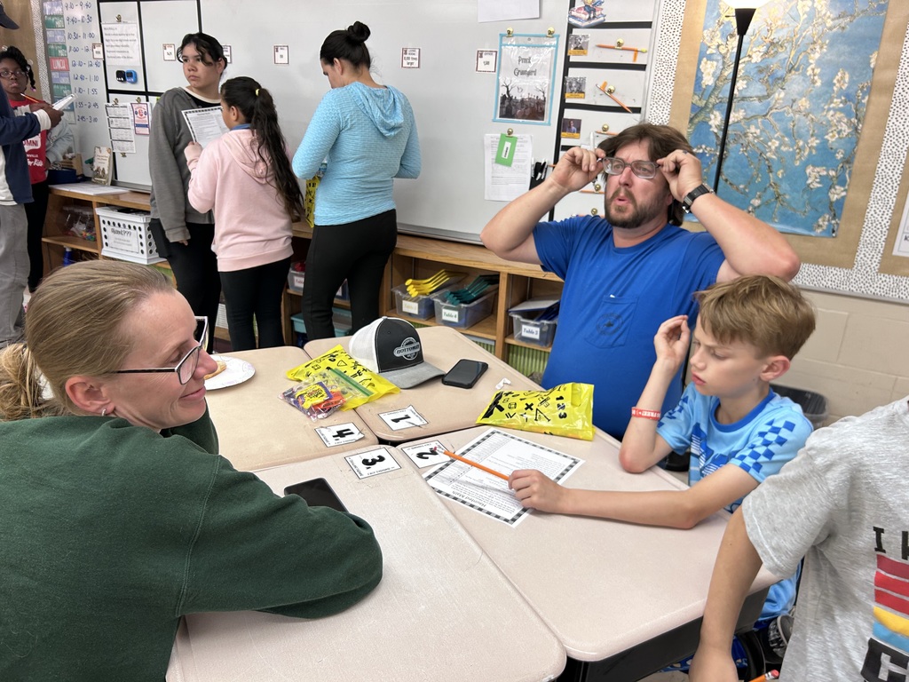 Families participating in hands on math activities with their students at MAJ.