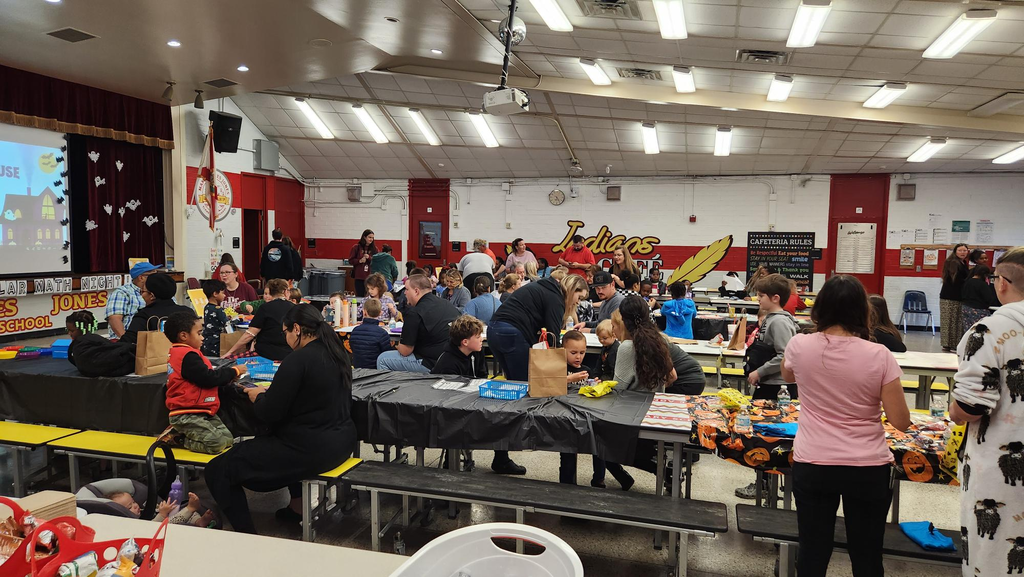 Families participating in hands on math activities with their students at MAJ.