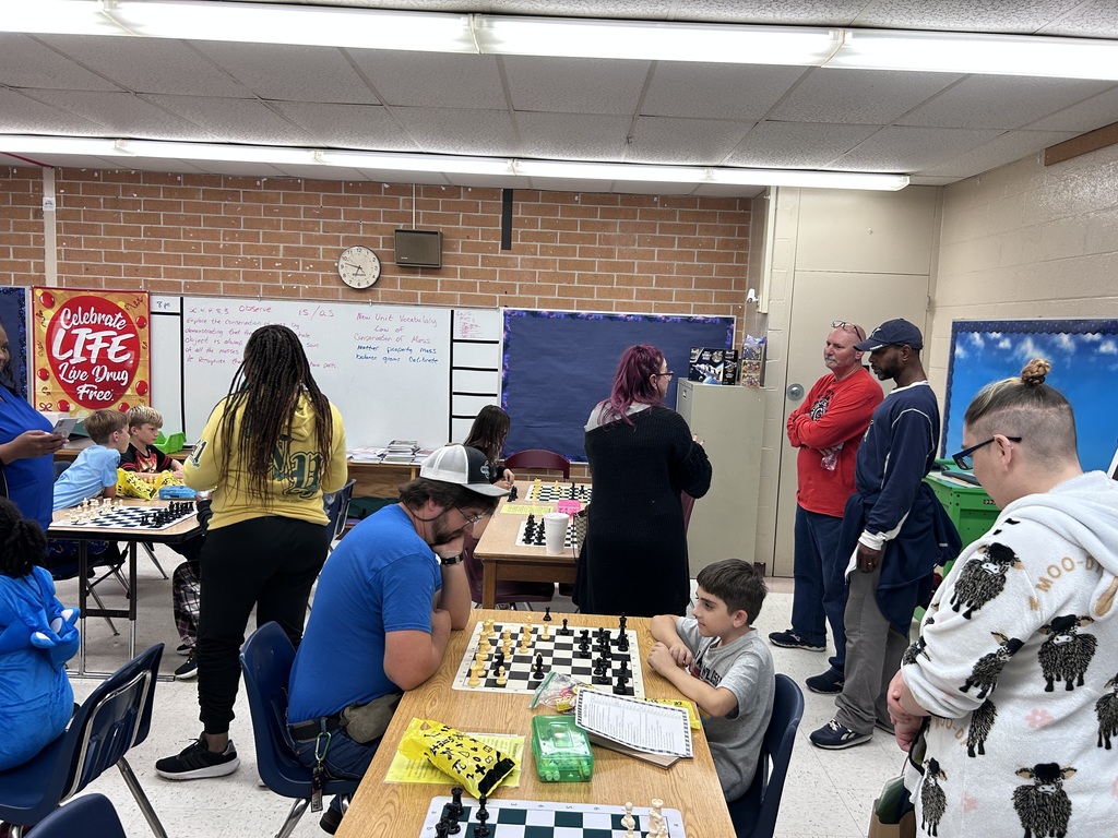 Families participating in hands on math activities with their students at MAJ.