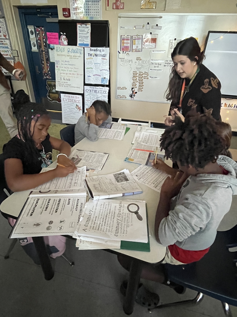 Ms. Adkinson working with a group of students