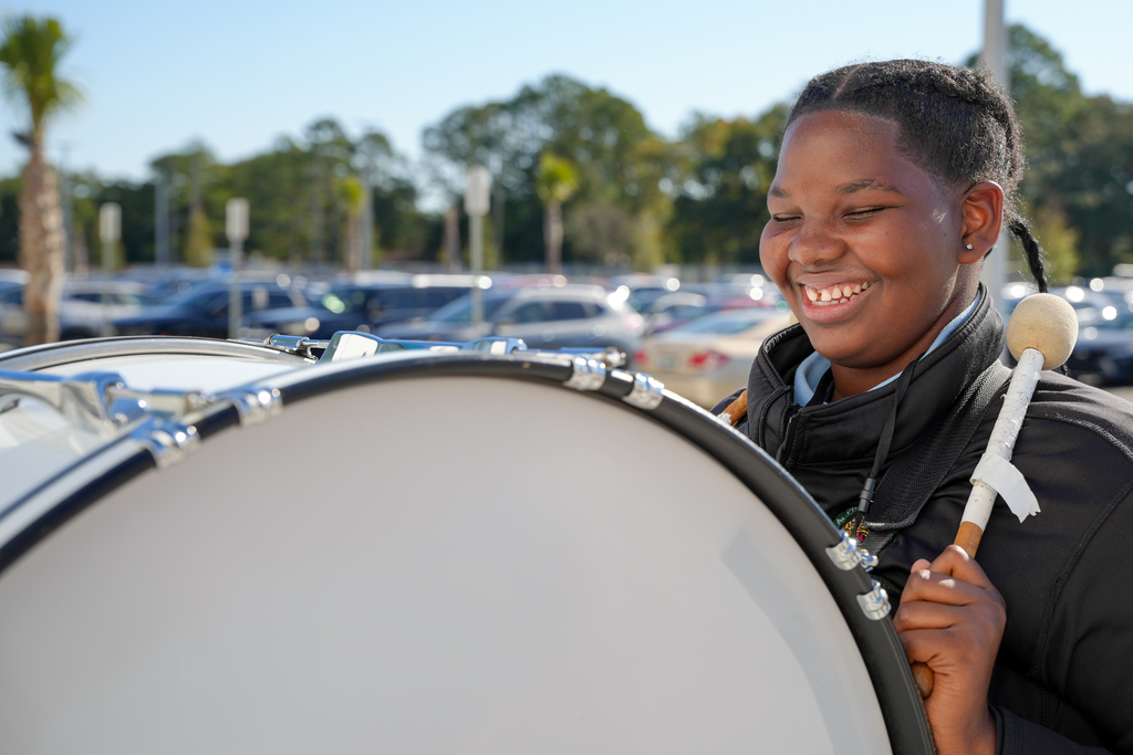 A Jean Ribault High School student plays a drum as part of the marching band welcome.