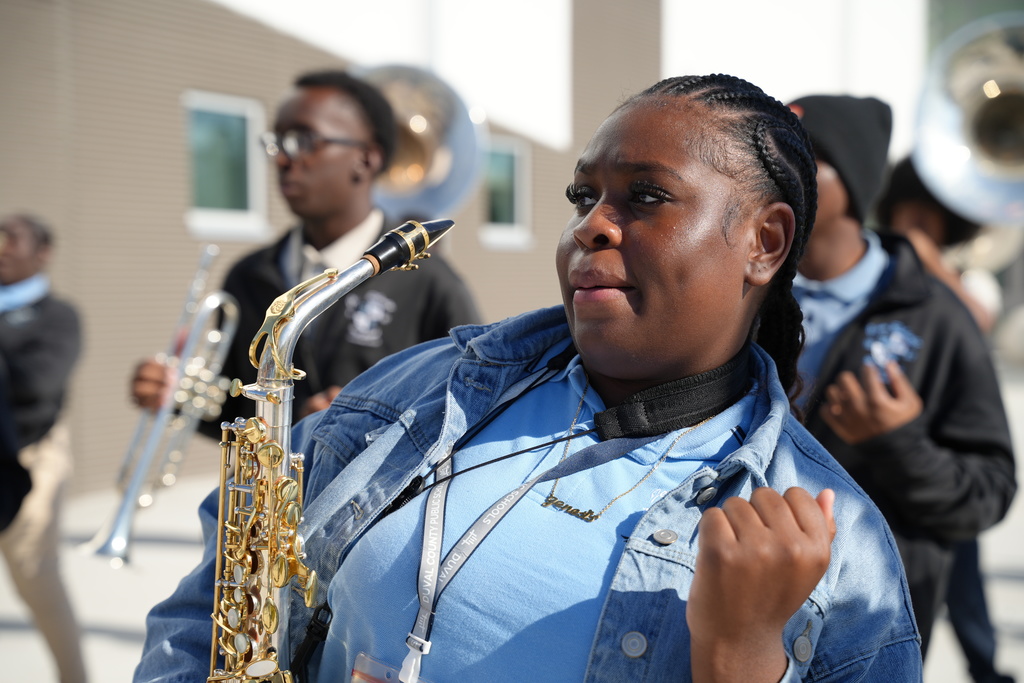 A Jean Ribault High School band member plays the saxophone during the welcome performance.