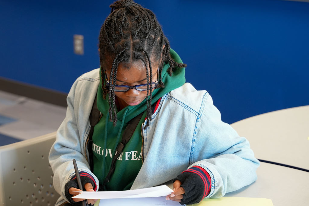 A Bethune-Cookman University student reviews paperwork during the school visit.