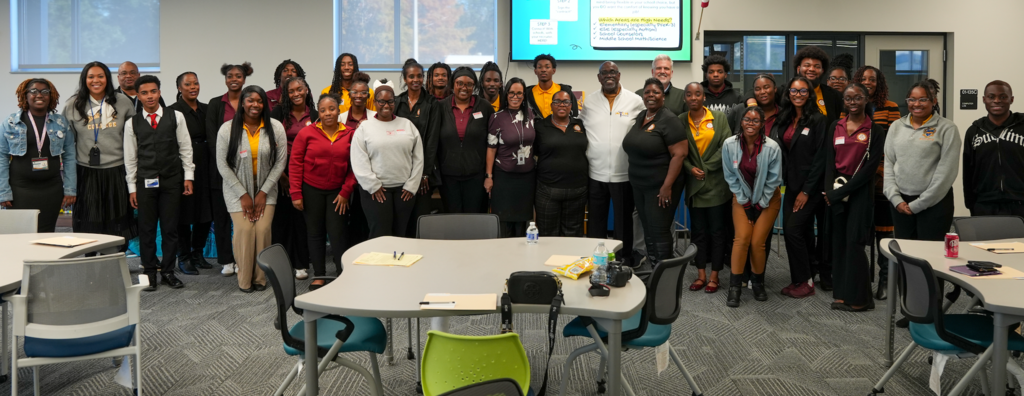 A large group of Bethune-Cookman University students, DCPS representatives, and Chaffee Trail Middle School staff gather for a group photo during the recruiting event.