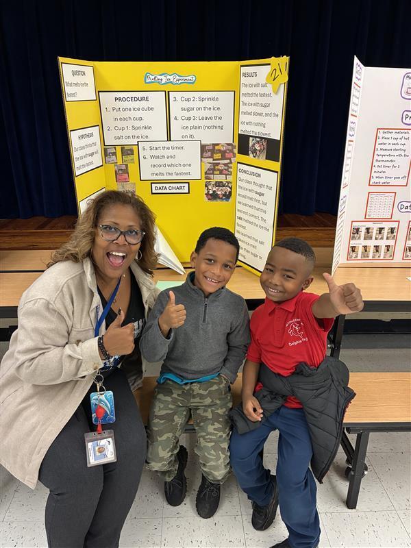 students and principal with science fair project