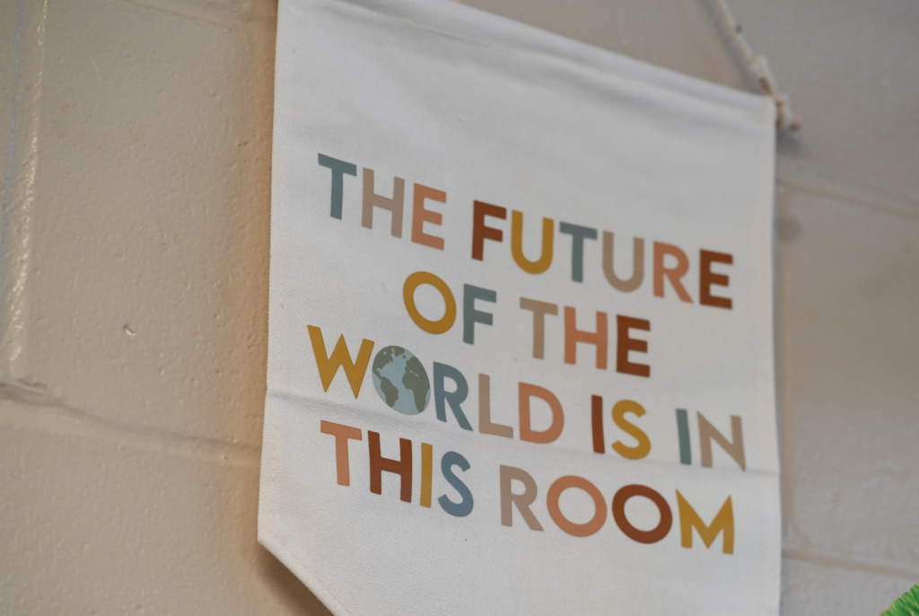 A classroom sign reads, “The future of the world is in this room.”