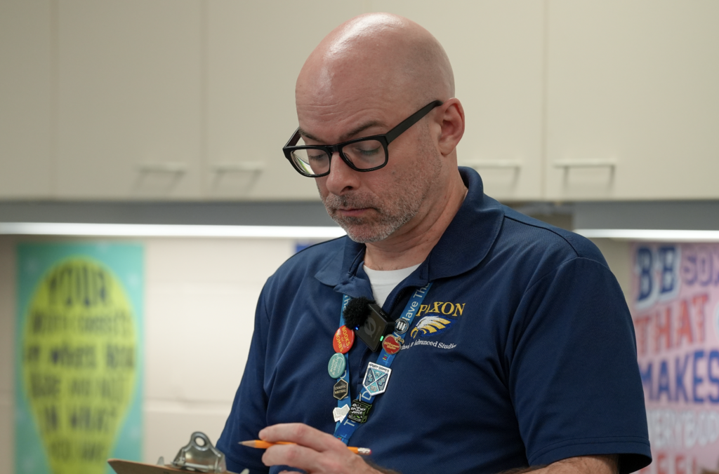Kevin Smith stands at the front of his classroom speaking to students at Paxon School for Advanced Studies.