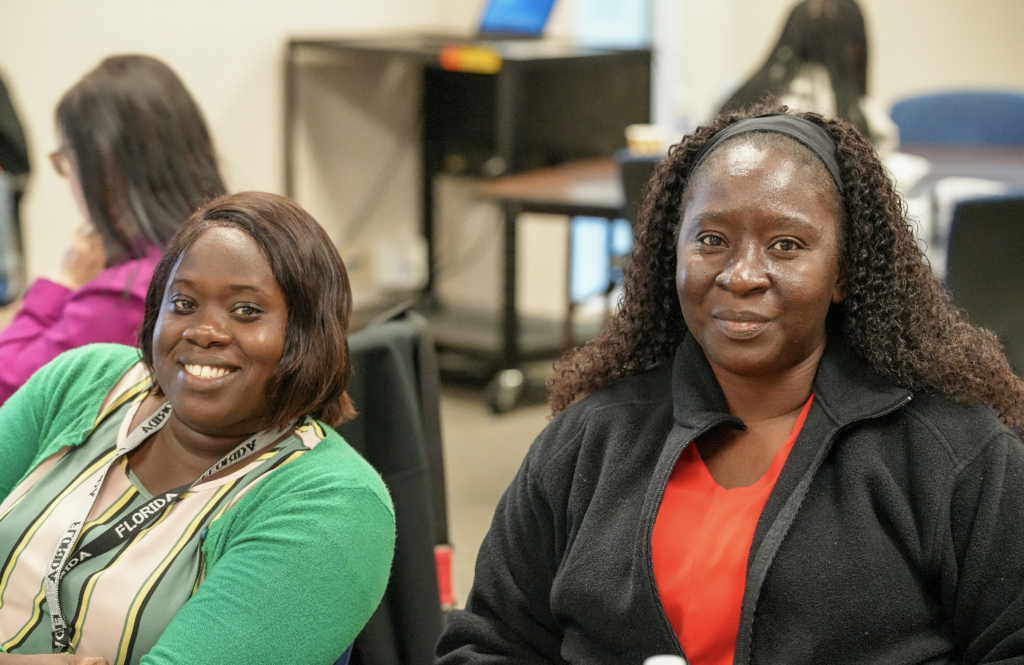 Smiling group of newly hired international teachers seated together during a Duval County Public Schools onboarding session.