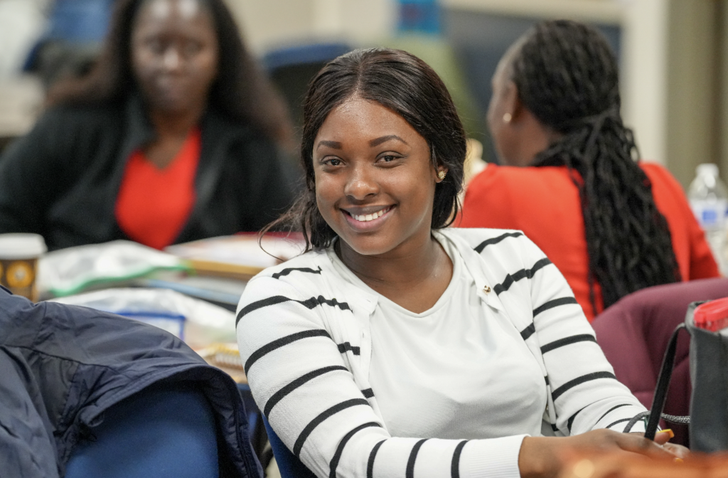 Portrait of a new international teacher smiling while attending onboarding with Duval County Public Schools.