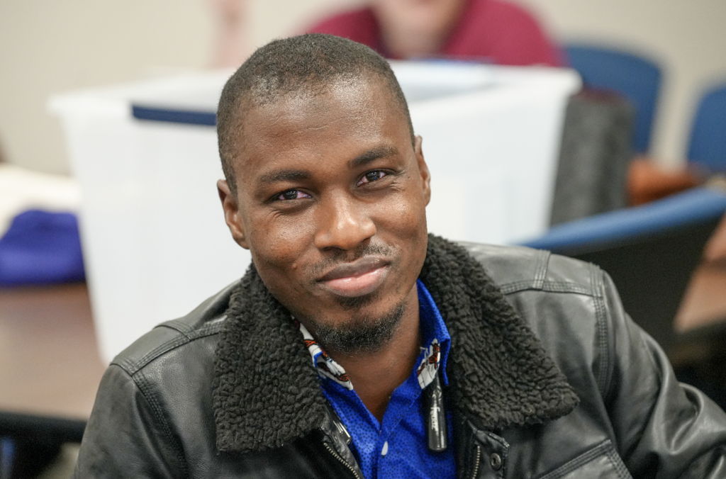Portrait of a new international teacher smiling while attending onboarding with Duval County Public Schools.