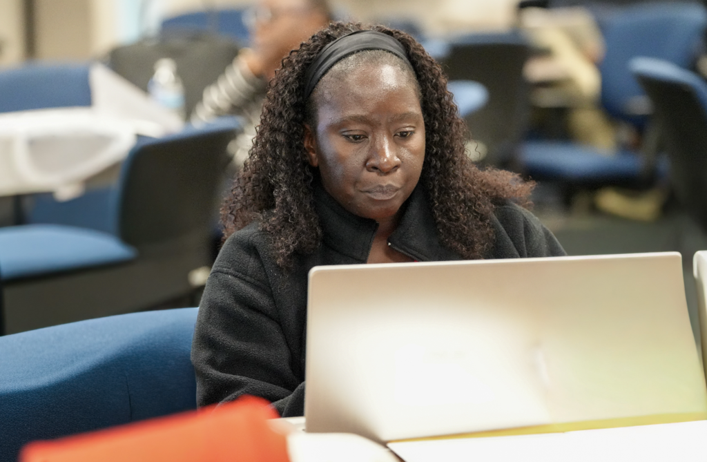 Portrait of a new international teacher seated indoors during onboarding with Duval County Public Schools.