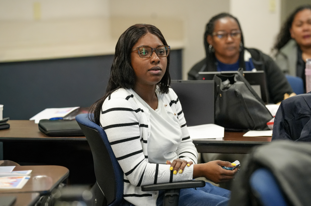 Portrait of a new international teacher seated indoors during onboarding with Duval County Public Schools.