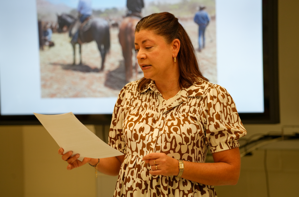 Spanish teacher Norma Crespo-Lowery works one-on-one with a student at a classroom table, reviewing written work during a lesson at Stanton College Preparatory School.