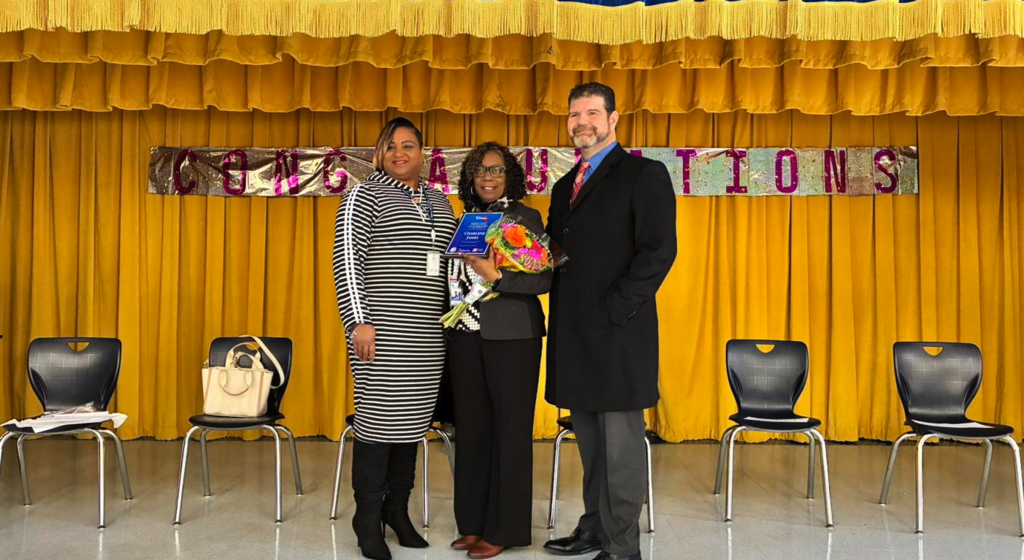 Florida TaxWatch representatives present the Principal Leadership Award to Principal James at George Washington Carver Elementary School.