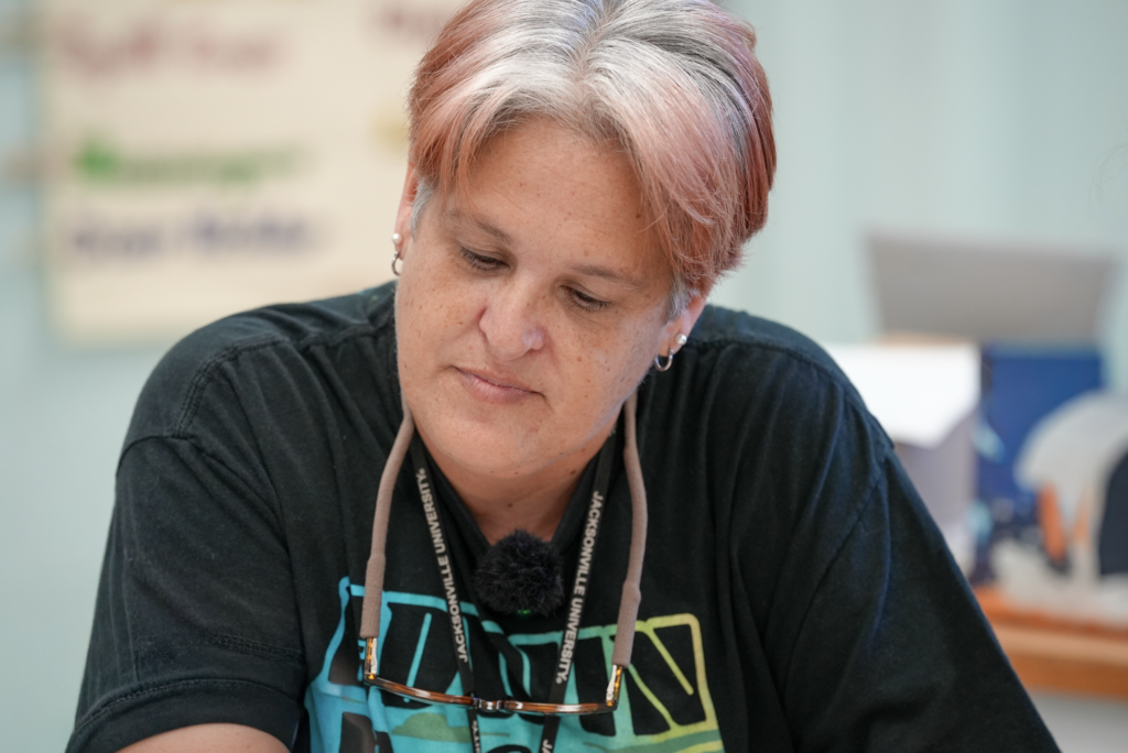 Elizabeth Dent sits at desk in classroom
