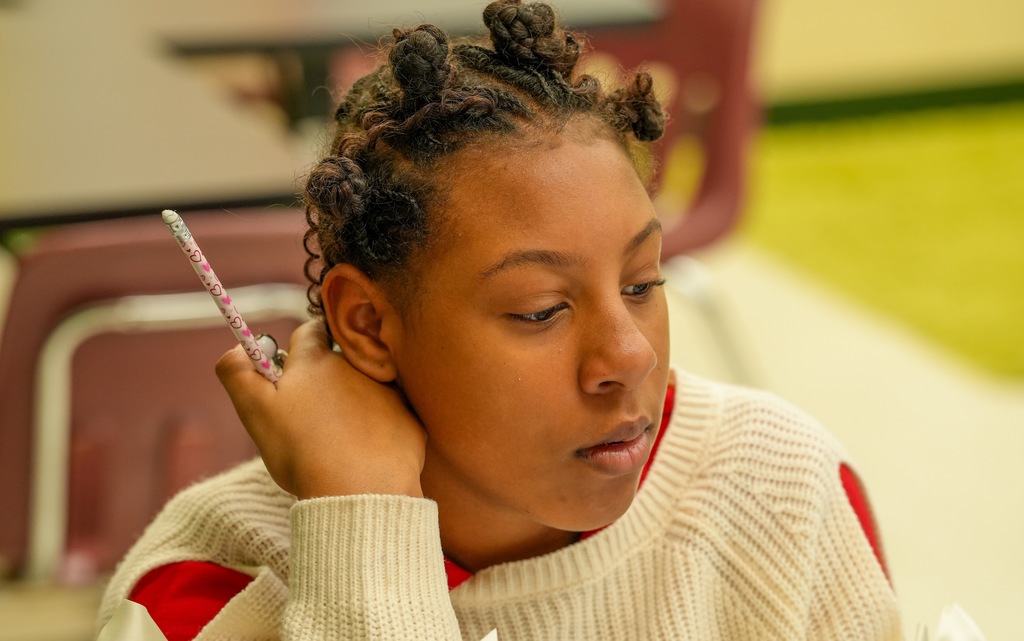 A student rests her head on her hand while concentrating on a math assignment during Benton Jones’ class at Fort Caroline Elementary School.