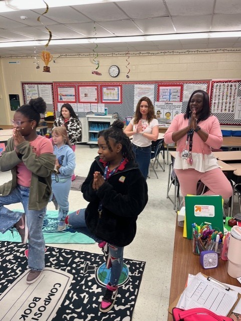 Girls with Pearls at Fort Caroline Elementary School practicing their yoga routine.