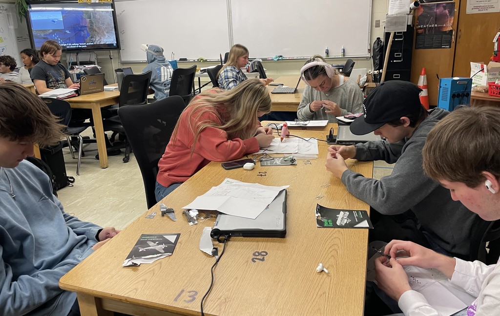 Students putting together model airplanes