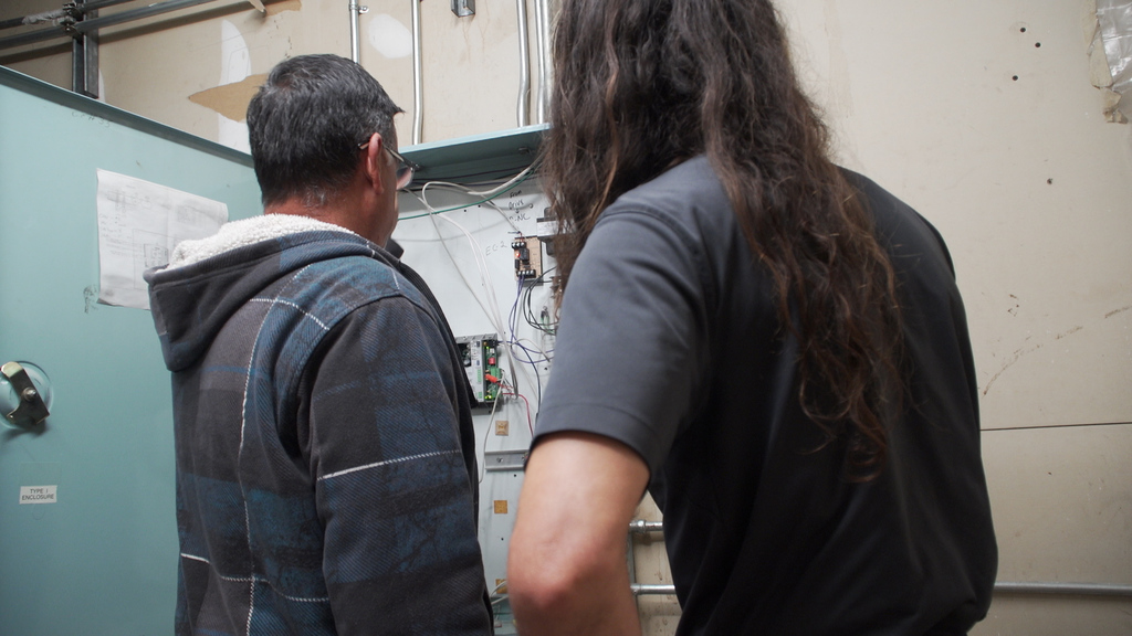 Two maintenance workers conduct an inspection.
