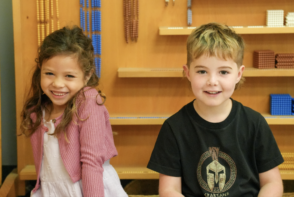 A young student sits at a desk focused on completing a classroom activity.