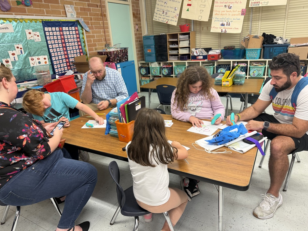 Student creating a flower using a 3-D pen. 