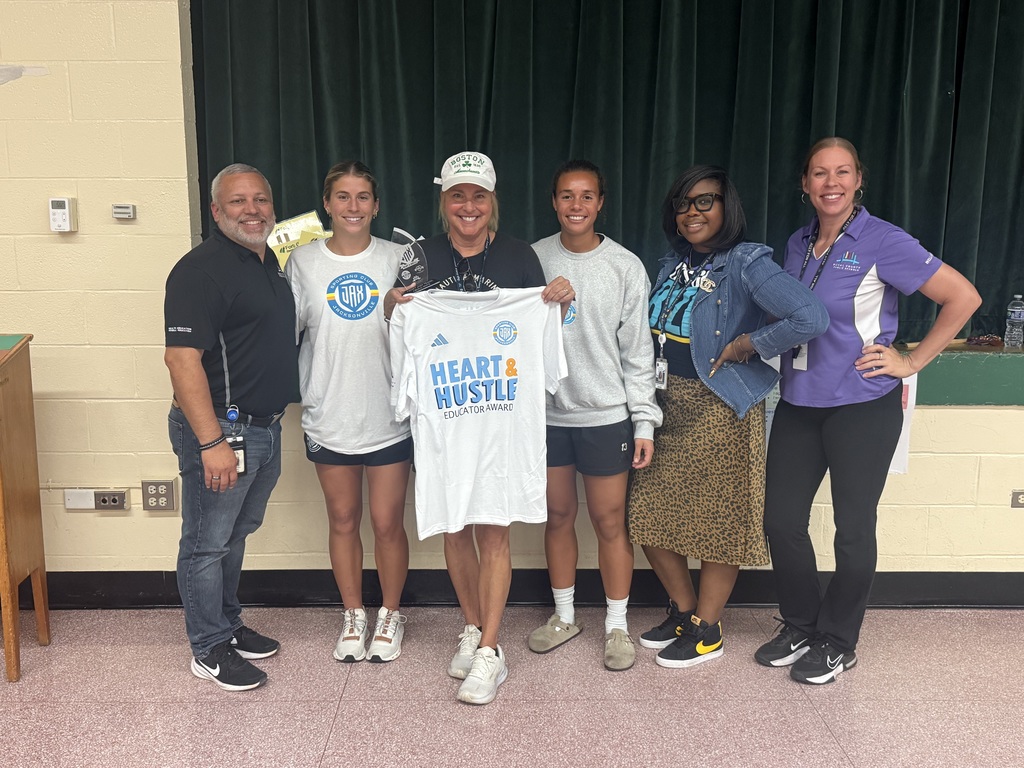 Coach Hall receiving the Heart and Hustle award from Jacksonville Sporting Club