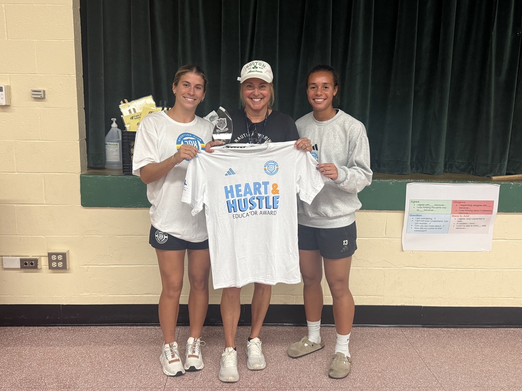 Coach Hall receiving the Heart and Hustle award from Jacksonville Sporting Club