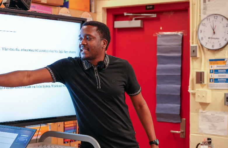 Teacher Randolph Myrie leading instruction and engaging students in his classroom