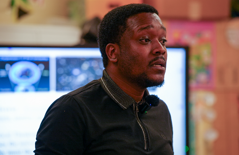 Teacher Randolph Myrie leading instruction and engaging students in his classroom