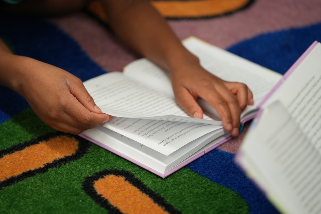 Student uses hands-on materials during an activity with Kadi Welty.