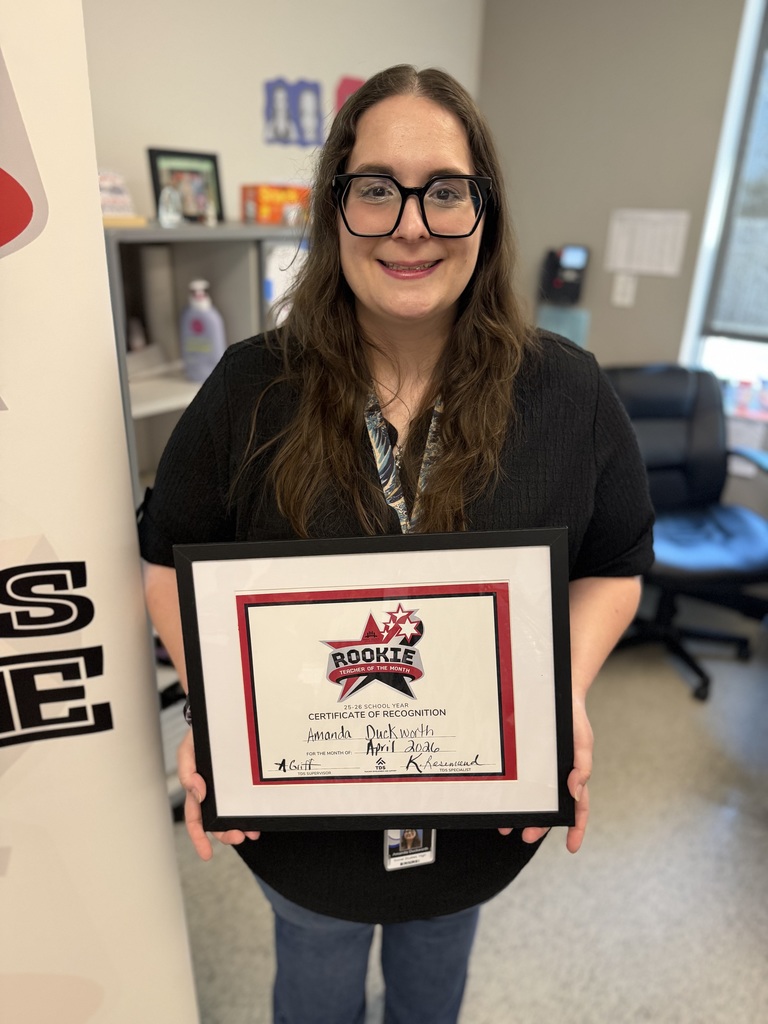 Close-up of Amanda Duckworth smiling and holding her Rookie Teacher of the Month certificate.