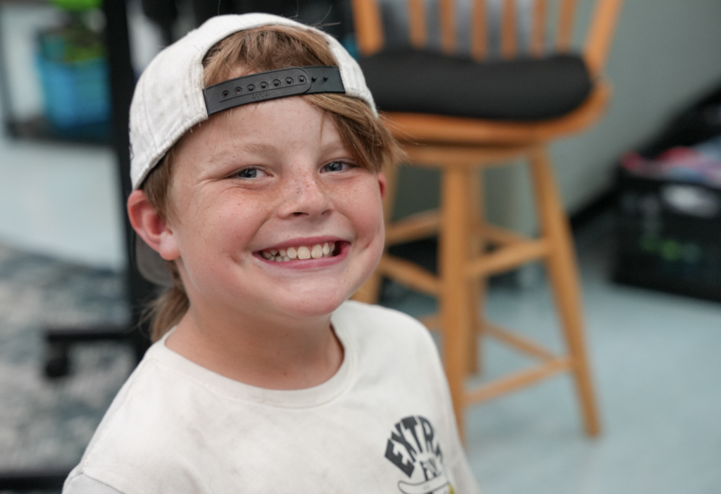 Student smiling while working at desk