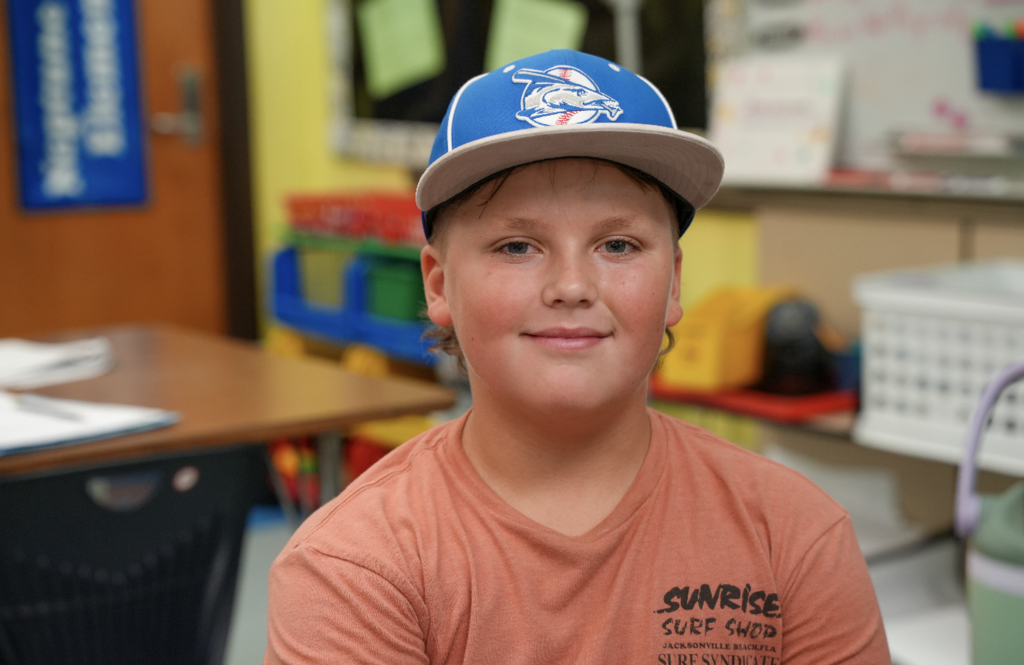 Student smiling while working at desk