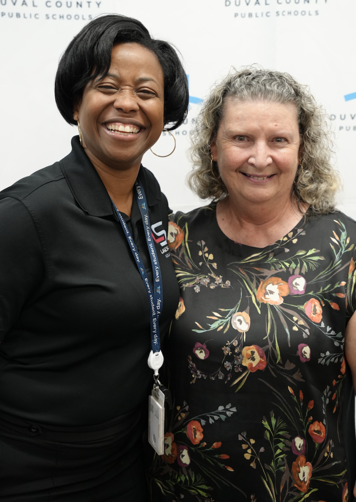 Two attendees smiling together at the Duval County Public Schools hiring fair