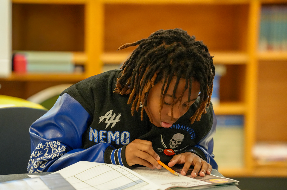 Student working on assignment with pencil