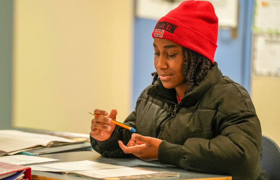Student working on assignment with pencil
