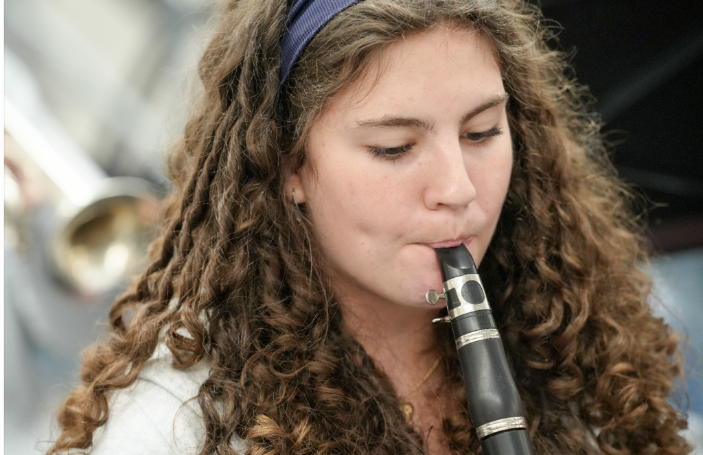 Student playing a clarinet during band practice