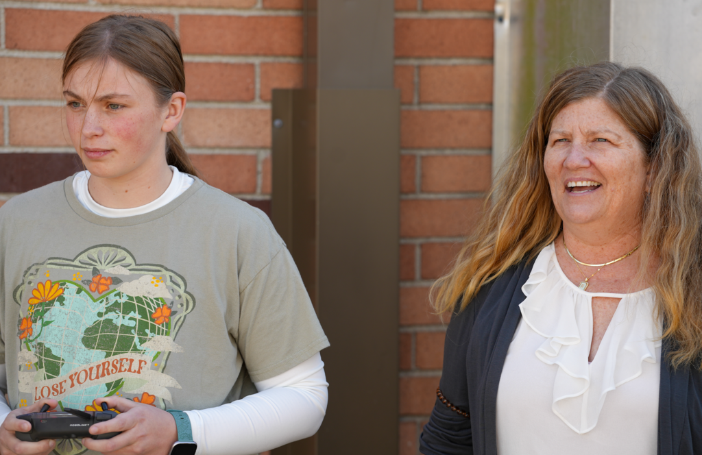 Elizabeth Michaels speaking with a student during a drone lesson